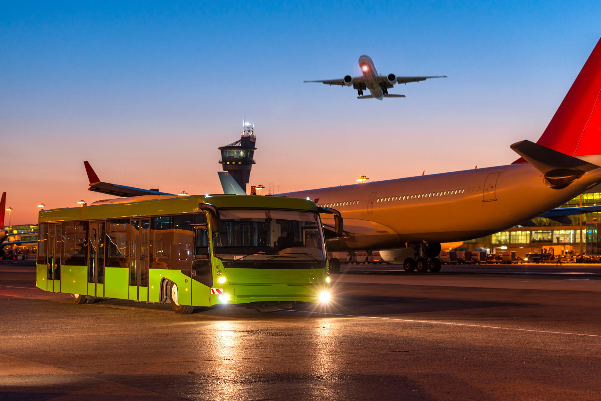 Airport bus and airplane at sunset