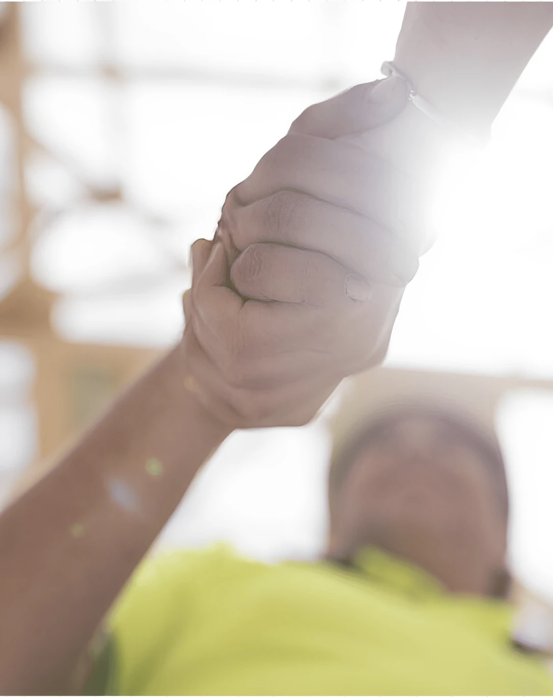 Handshake with bright sunlight in background.
